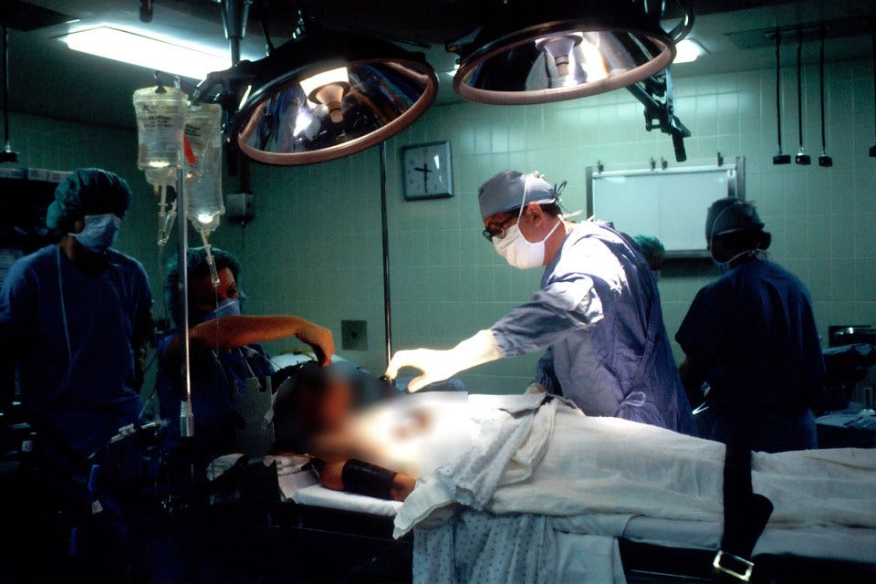 Surgeons performing surgery in an operating room. Surgeons performing surgery in an operating room.