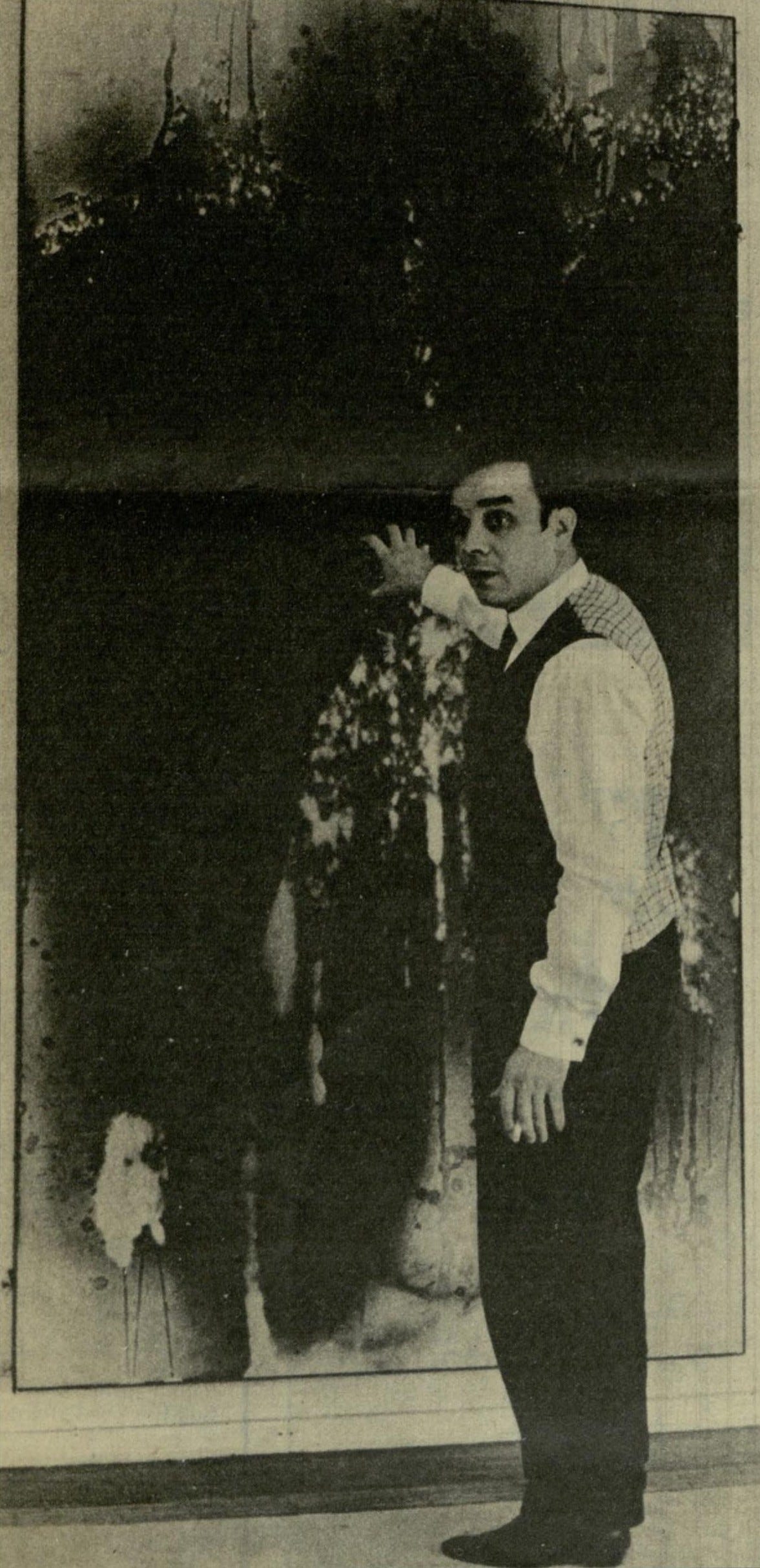 Yves Klein in front of one of his canvases, 1962
