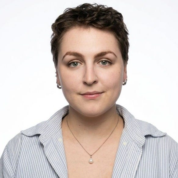 Head-and-shoulders portrait of author Leon Craig, with short dark hair, hoop earrings and a striped shirt against a white background. Photograph by Corinne Biglietti. Head-and-shoulders portrait of author Leon Craig, with short dark hair, hoop earrings and a striped shirt against a white background. Photograph by Corinne Biglietti.