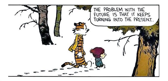 Calvin stands in a snowy forest with trees and bare branches, wearing a red coat and hat, with short brown hair and a thoughtful expression. Hobbes the tiger with orange and black stripes stands behind him. A speech bubble from Hobbes reads The problem with the future is that it keeps turning into the present.