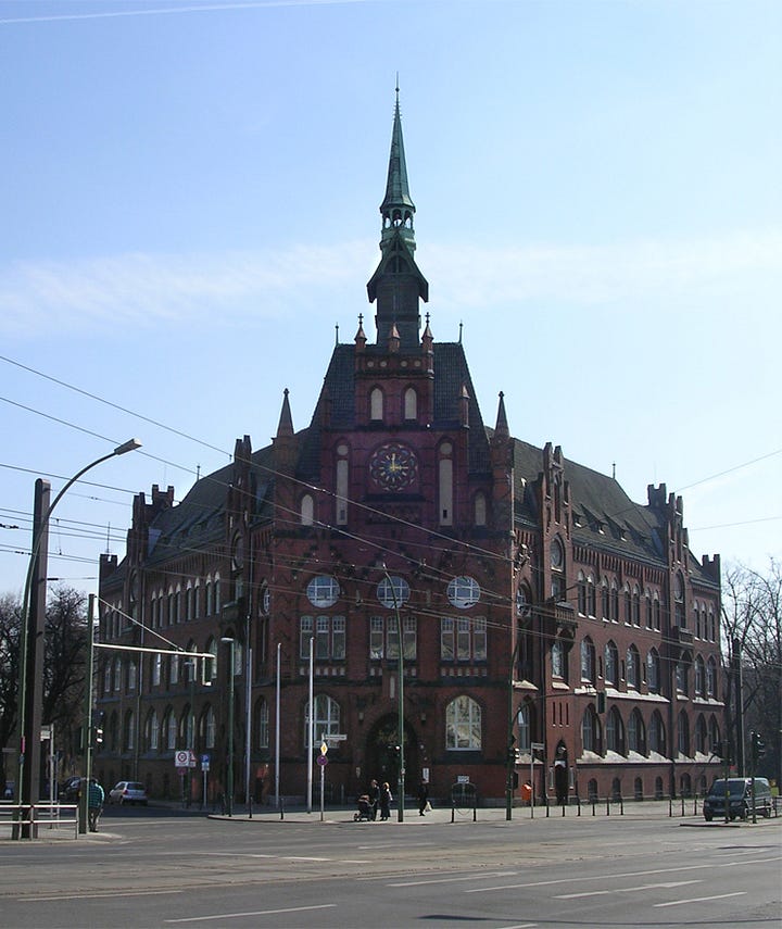 Two photos of the Rathaus Lichtenberg in Berlin published side by side. The left is a color photo from 2005 and the right is a black-and-white image from 1909.