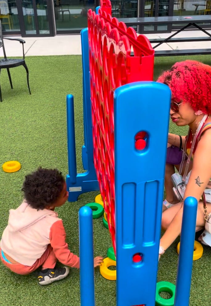 Kiana playing giant connect four with her godson