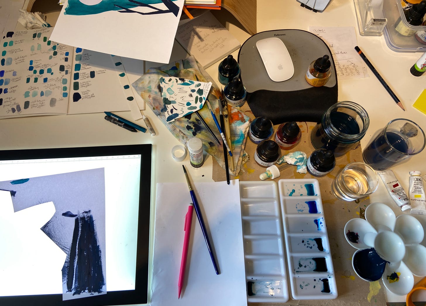 Photo of messy desk full of art materials
