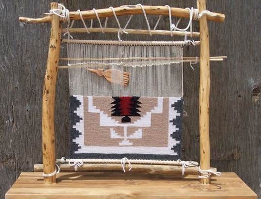 This may contain: an old weaving loom is sitting on top of a cushion with a red, white and black design