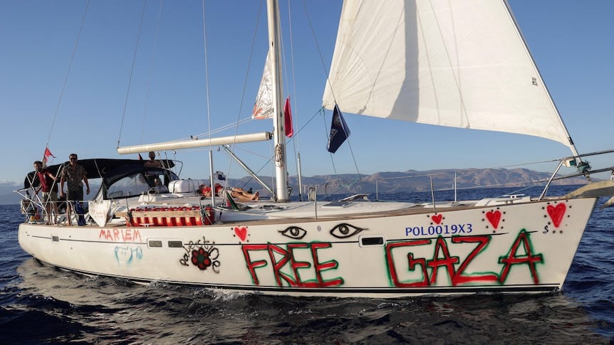 a sailing boat with free gaza written on the side in red paint