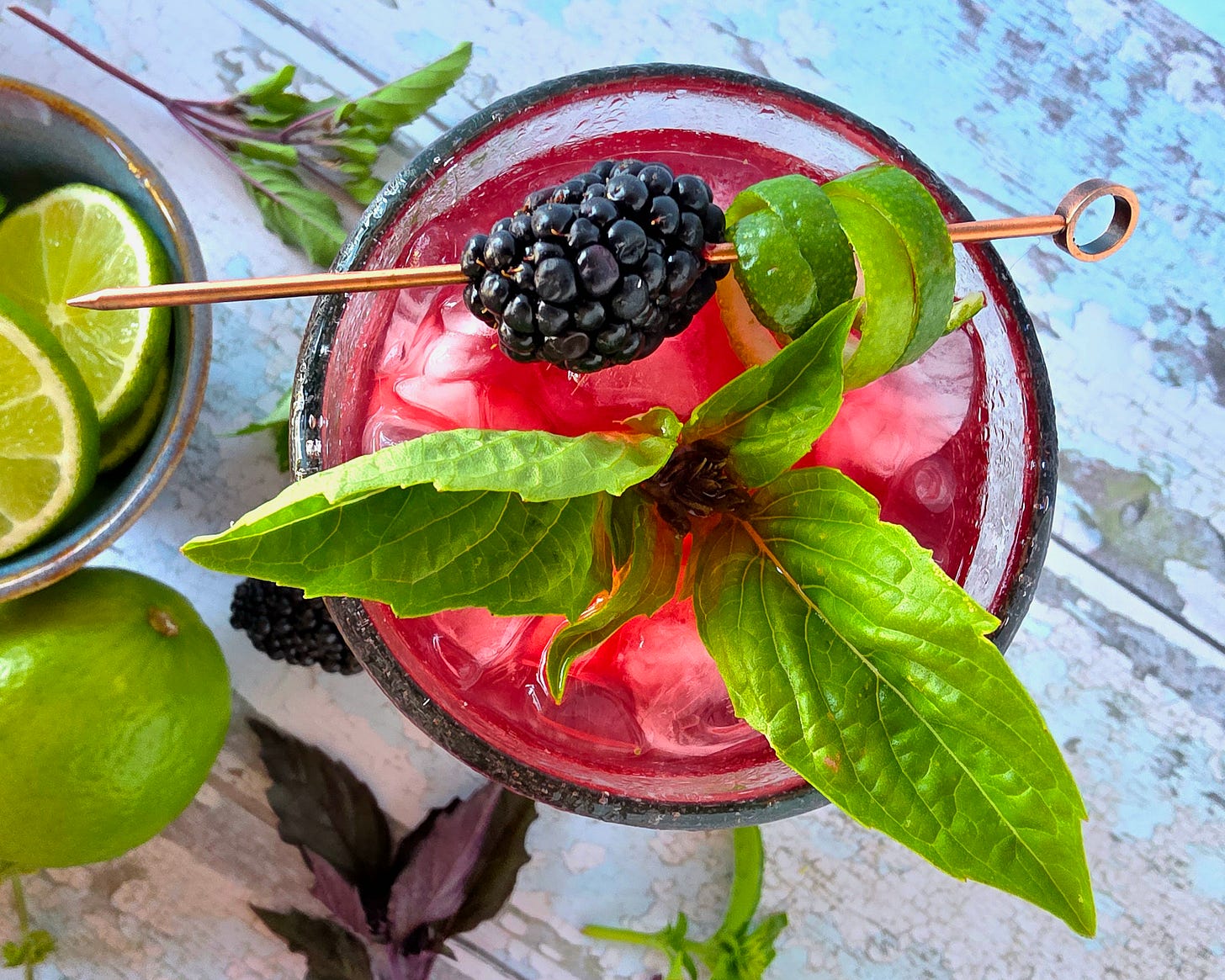 an overhead view of a cocktail with garnishes