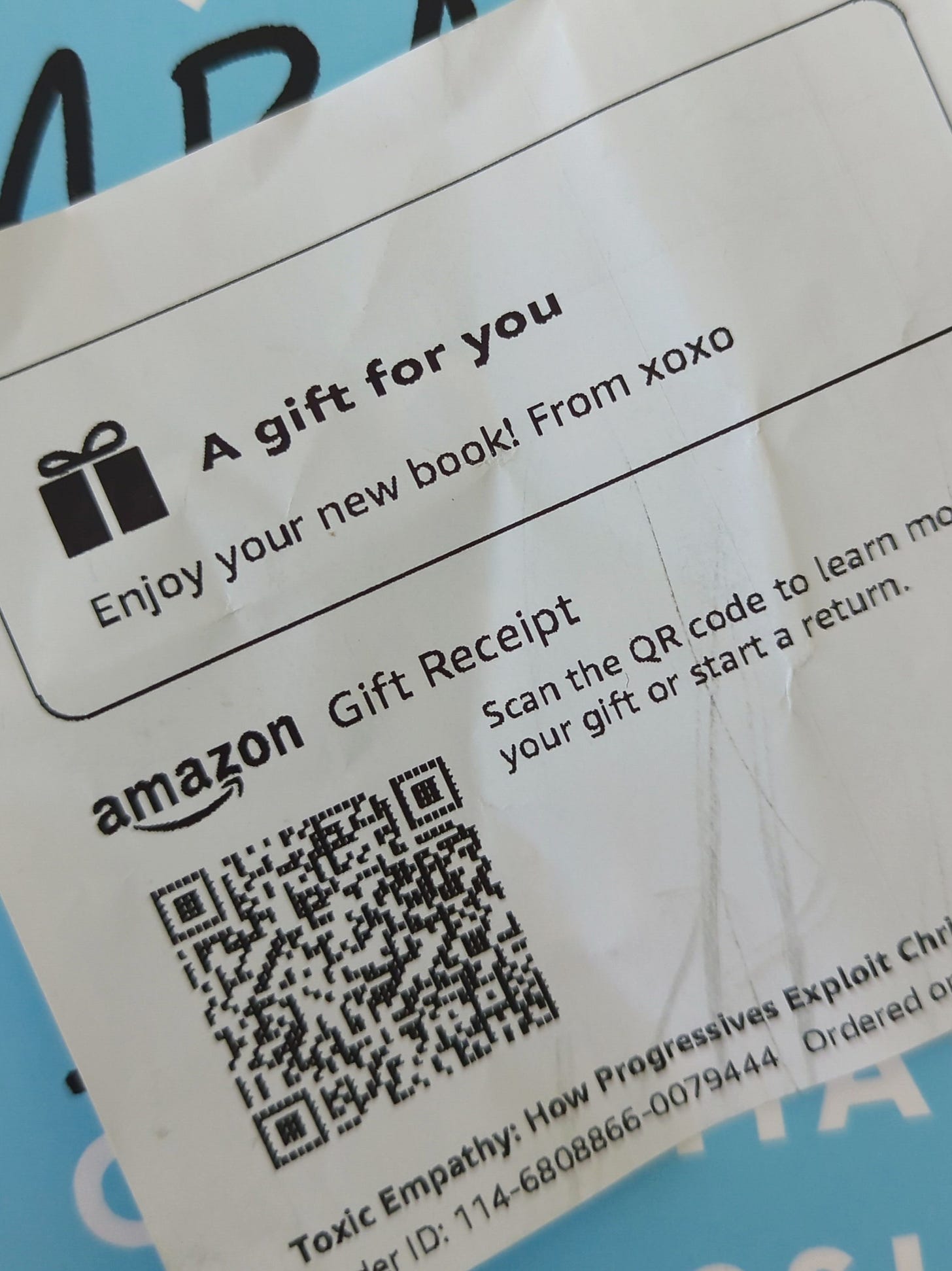 photo of an Amazon gift receipt that reads, "Enjoy your new book! From, xoxo"