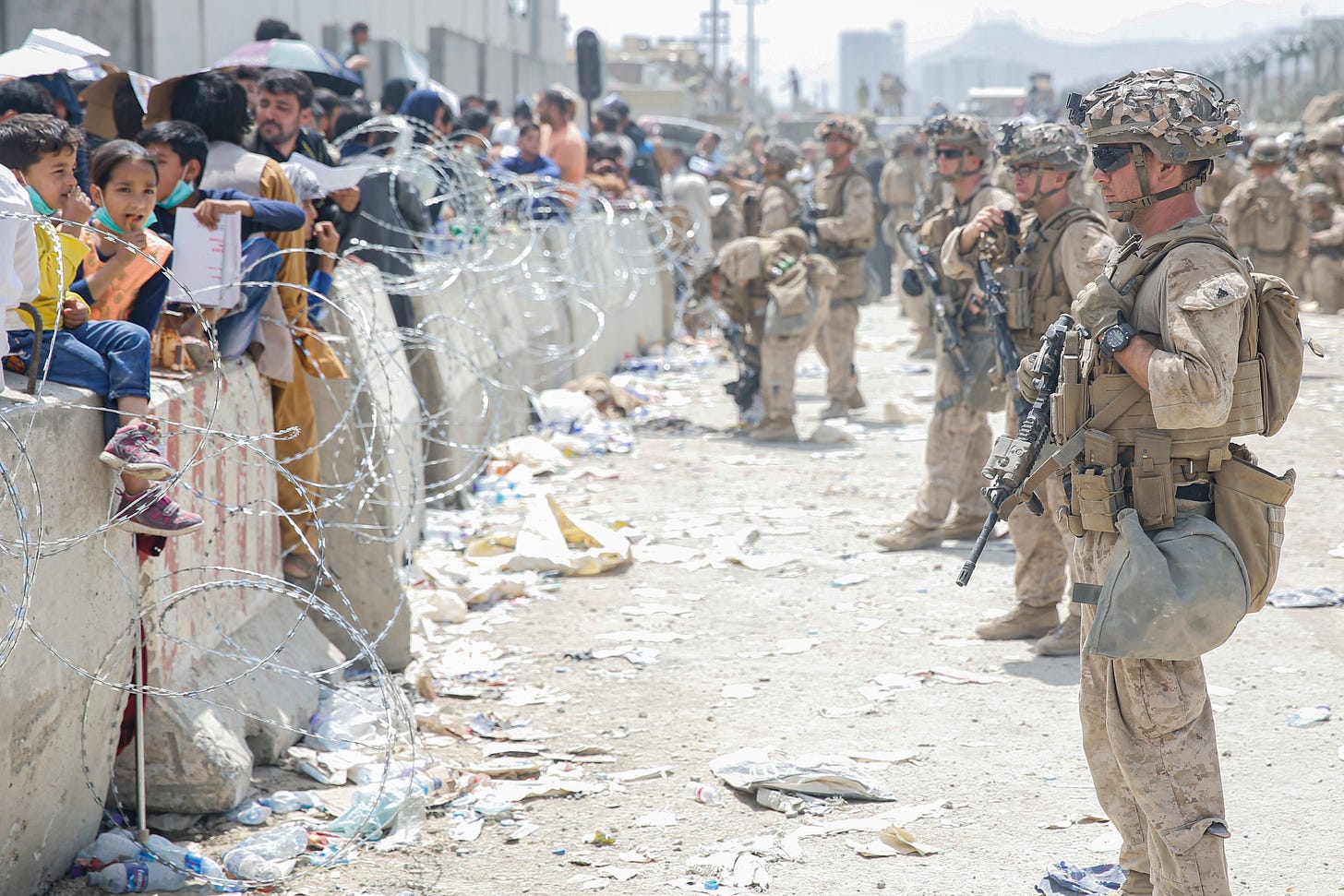 U.S. Marines with Special Purpose Marine Air-Ground Task Force - Crisis Response - Central Command, provide assistance during an evacuation at Hamid Karzai International Airport, Kabul, Afghanistan, Aug. 20. U.S. service members are assisting the Department of State with an orderly drawdown of designated personnel in Afghanistan. (U.S. Marine Corps photo by Lance Cpl. Nicholas Guevara) 