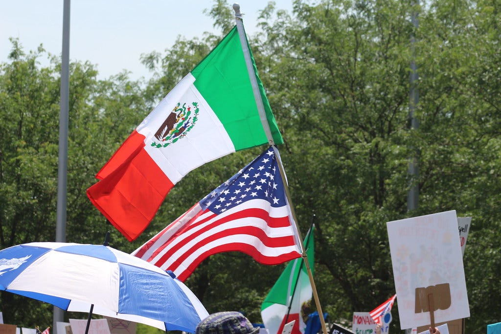 Photo: An American Flag is placed beneath a Mexican Flag at the No Kings protest.