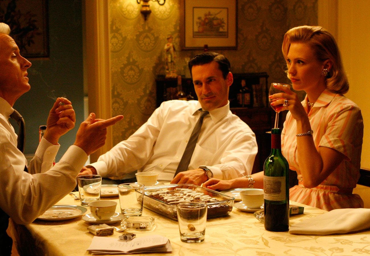 Roger, Don, and Betty at the Drapers’ dinner table in Mad Men.