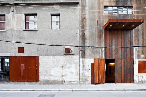 Neri&Hu — The Waterhouse at South Bund, Shanghai. Former 1930s Japanese army headquarters converted into a boutique hotel. Raw concrete, preserved industrial structure, and original markings held deliberately as identity rather than erased.