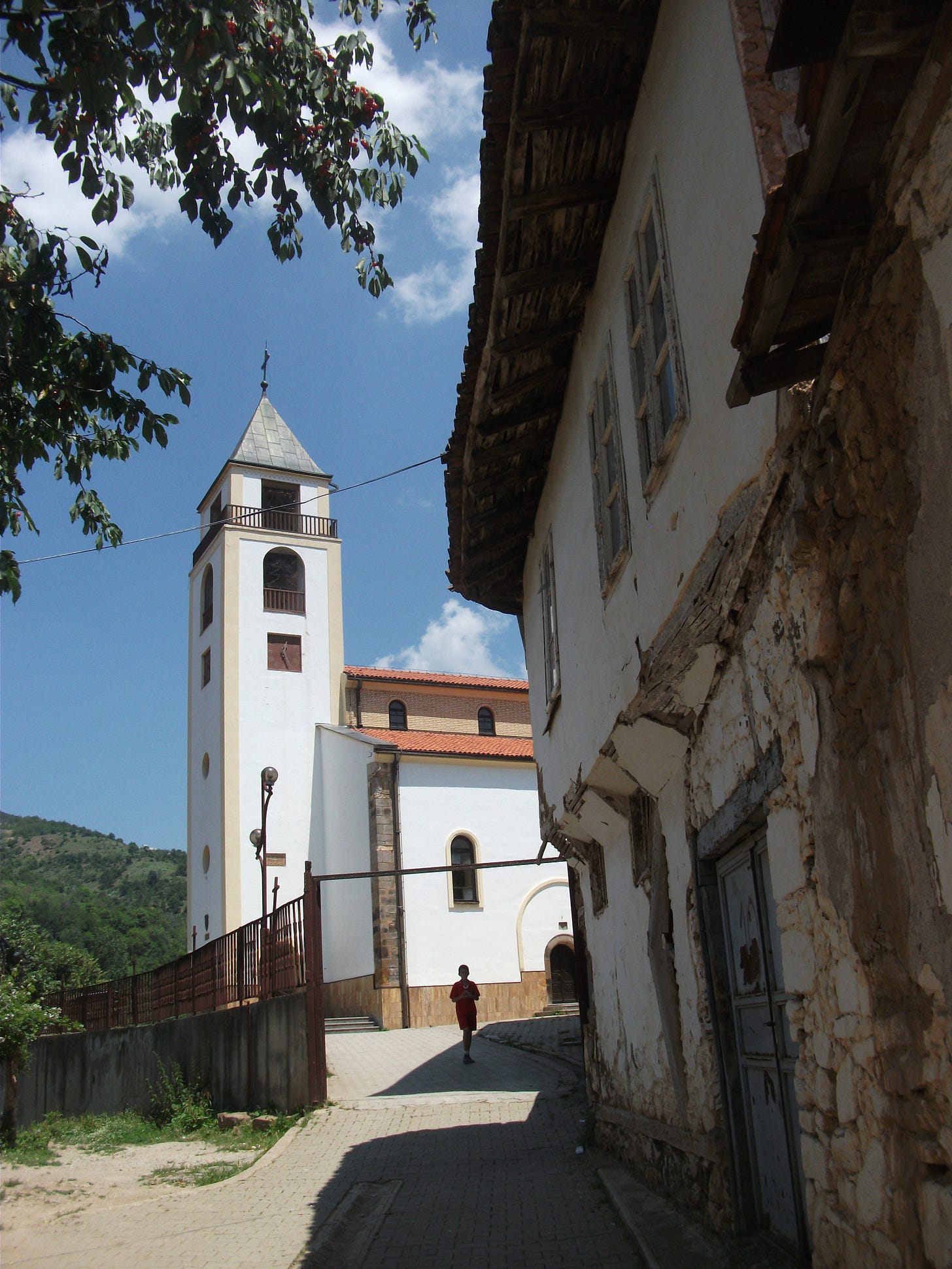 A sunny day with a white church tower and old whitewashed building A sunny day with a white church tower and old whitewashed building