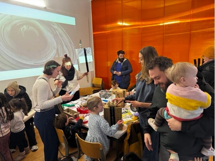 young people and families taking part in making robots out of cardboard boxes