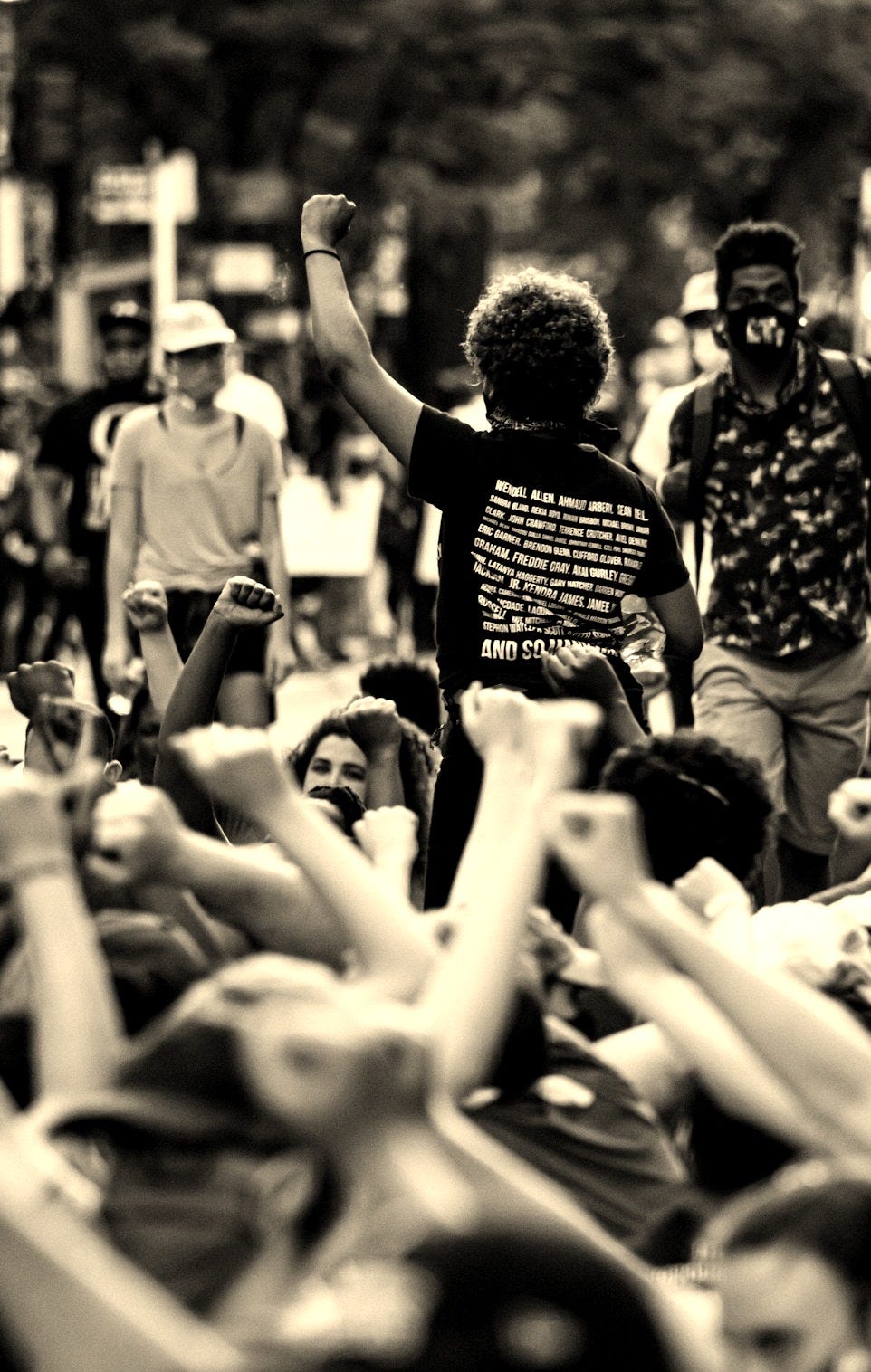 a group of people standing around each other a group of people standing around each other