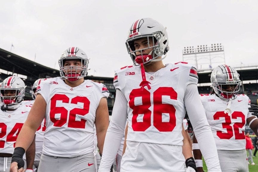 Maxence LeBlanc stands beside teammates on the field during an Ohio State Buckeyes football game Maxence LeBlanc stands beside teammates on the field during an Ohio State Buckeyes football game