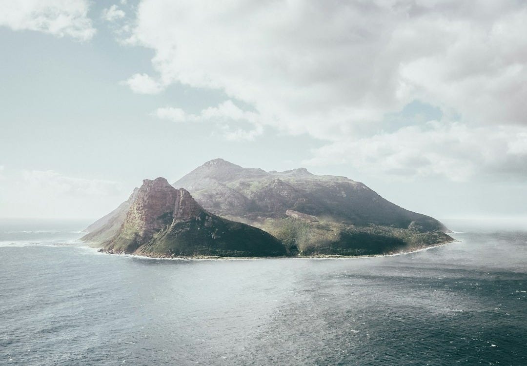 bird's eye view photography of island under white clouds bird's eye view photography of island under white clouds
