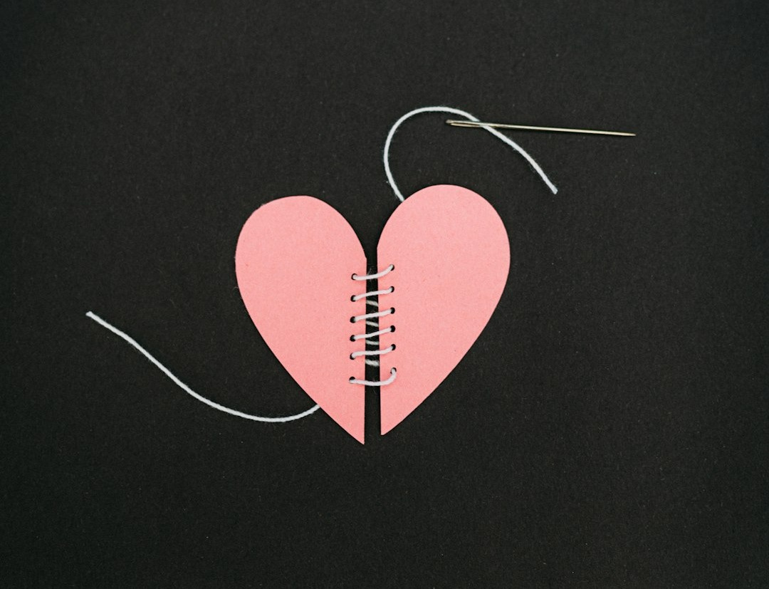 a broken heart with a string attached to it