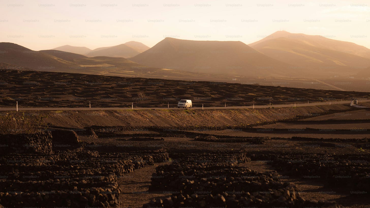 a truck is driving down a dirt road