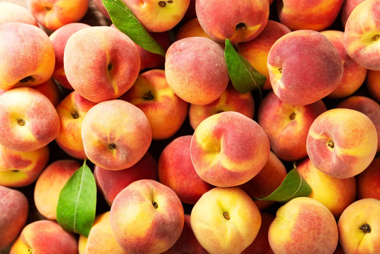 fresh peaches as background, top view