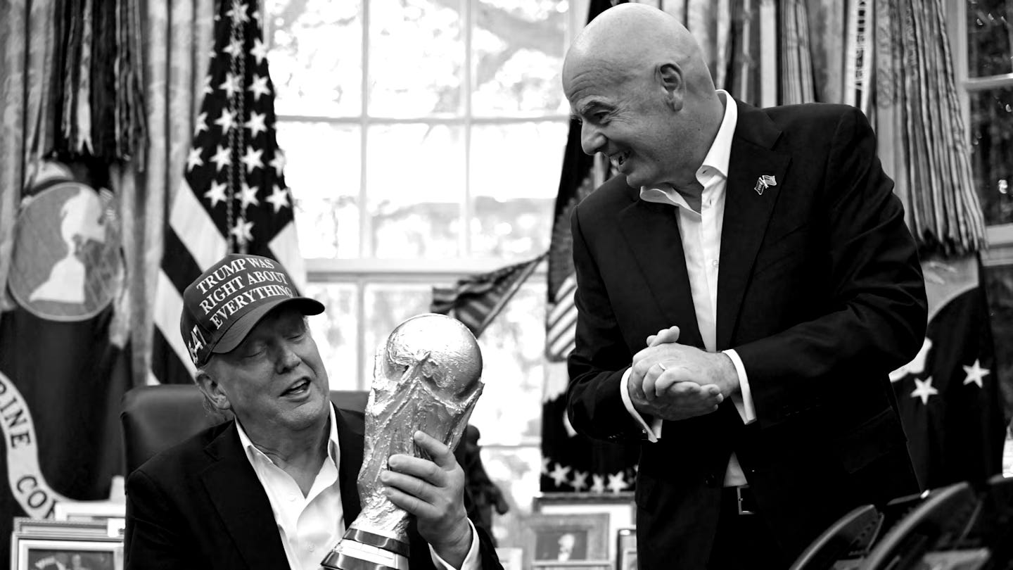 Donald Trump, wearing a red hat, holds the Fifa World Cup trophy while Gianni Infantino stands nearby smiling. Donald Trump, wearing a red hat, holds the Fifa World Cup trophy while Gianni Infantino stands nearby smiling.