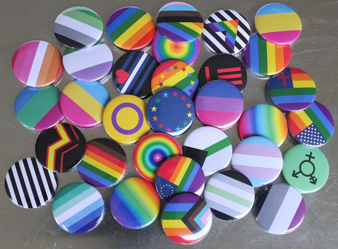 a pile of colorful buttons sitting on top of a table a pile of colorful buttons sitting on top of a table