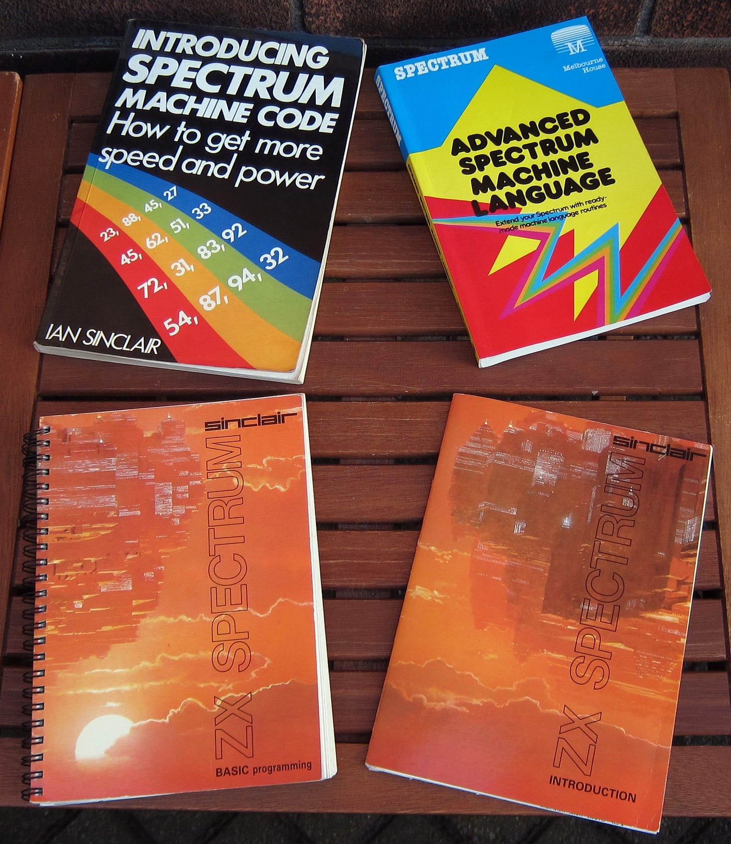 Four ZX Spectrum books. The two manuals, plus Introducing Spectrum Machine Code and Advanced Spectrum Machine Language. 