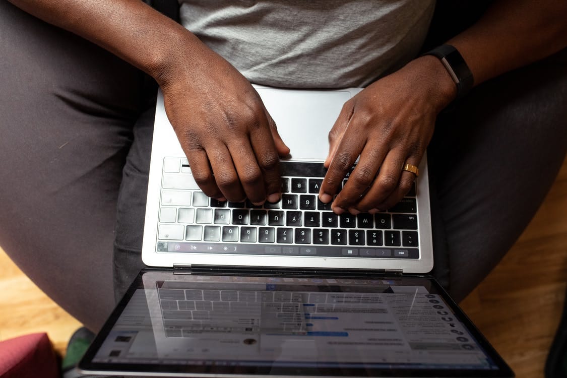 Man Typing on His Laptop