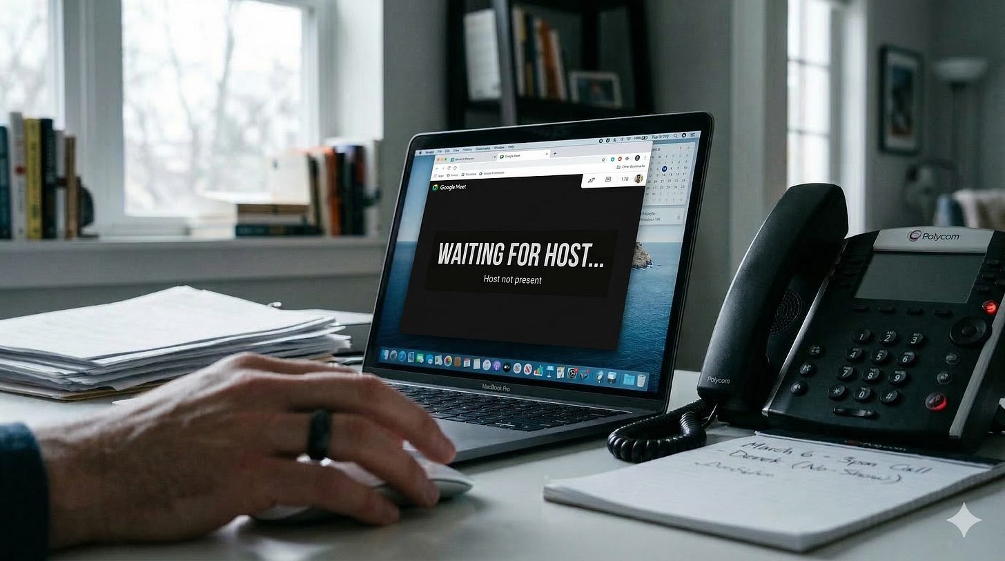 A documentary-style, horizontal photograph from the first-person perspective of someone waiting in a home office. The lighting is soft and natural from a nearby window. In the foreground, a man’s hand rests on a metallic mouse next to a stack of papers and a notepad with blurred, illegible handwriting. The primary focus is a laptop screen displaying a generic, dark video conferencing window. Centered on the screen in large, bold, white sans-serif font is the text: "WAITING FOR HOST..." and in smaller text below it, "Host not present." To the right, a black desk phone sits with a dark, unlit screen. The image conveys a sense of professional isolation and the waste of time inherent in broken operational processes.