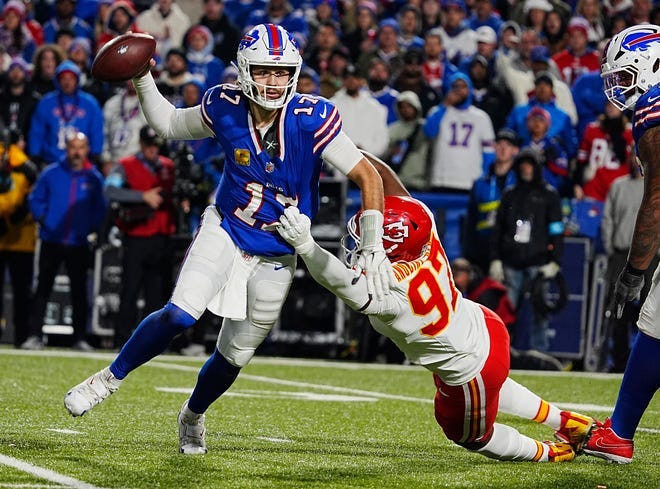 Bills quarterback Josh Allen runs laterally to find an open receiver. He gets the pass off before Kansas City's Felix Anundike-Uzomah sacks him during second half action against the Kansas City Chiefs in Orchard Park, Nov.17, 2024.