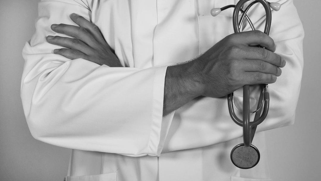 doctor holding red stethoscope doctor holding red stethoscope