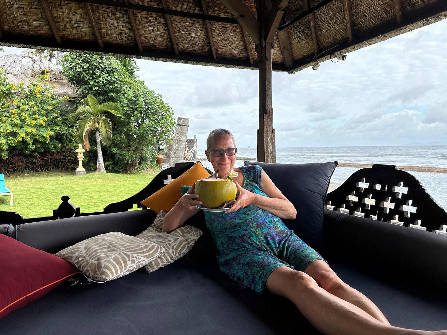 Laura Davis drinking coconut water out of a coconut in Bali