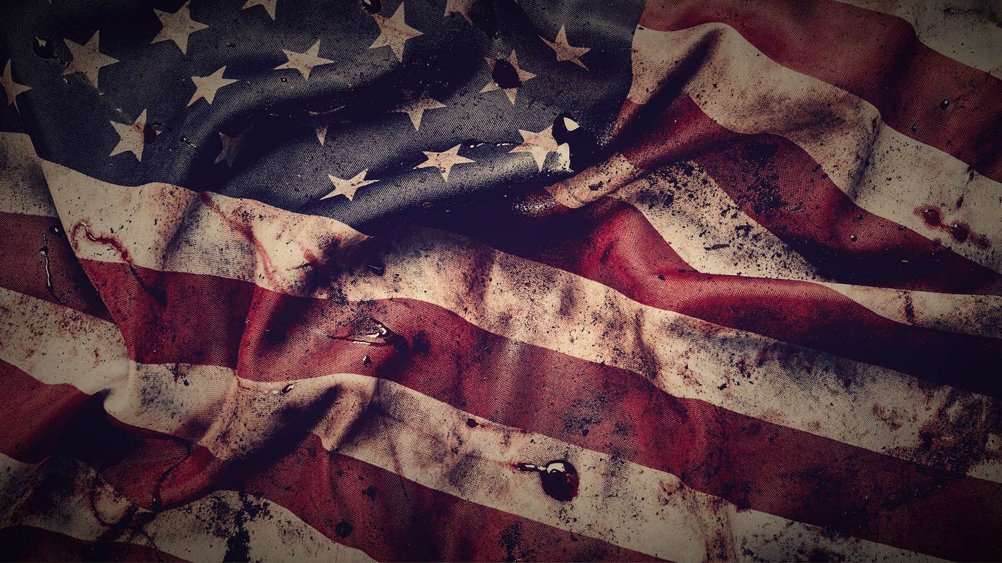 Closeup of dirty bullet holed and bloody American flag.