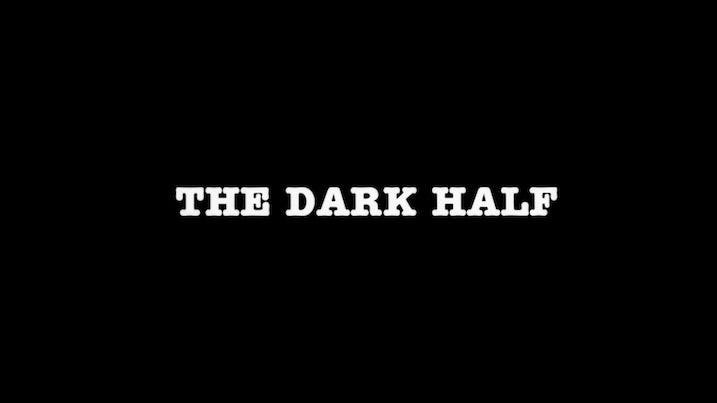 Black screen with “THE DARK HALF” centered in white, serif-style block lettering. Simple, stark, and ominous — the film’s opening title.