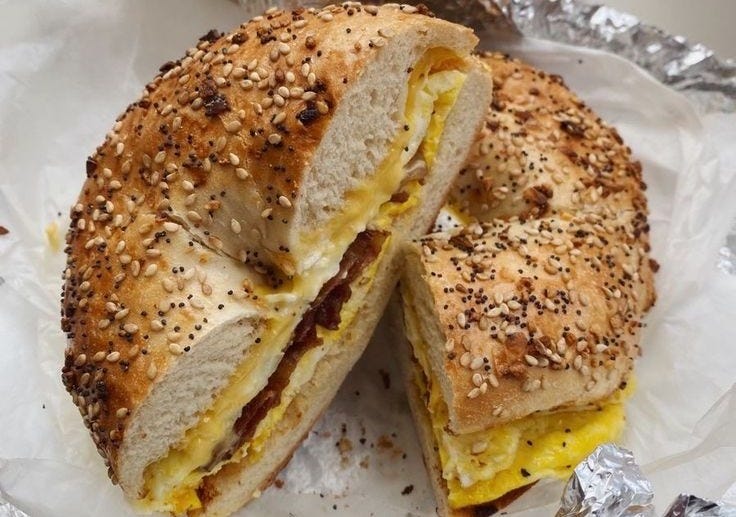 This may contain: a sandwich cut in half sitting on top of foil