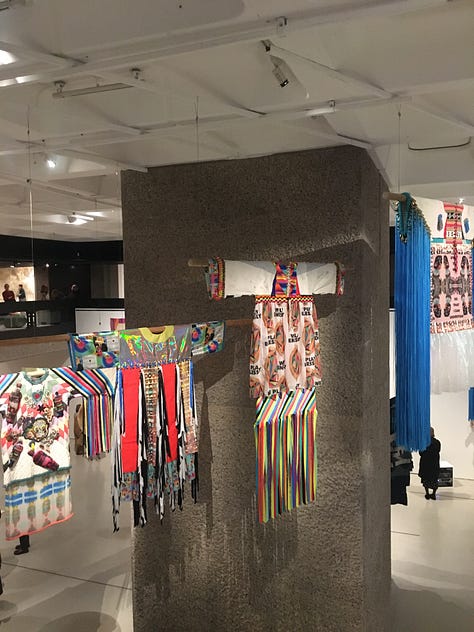 The exhibition viewed from the mezzanine showing large-scale works from — 1. Cecilia Vicuña (top) and Sarah Zapata (bottom); 2. Jagoda Buić (right) and Mrinalini Mukherjee (left); 3. Jeffrey Gibson.