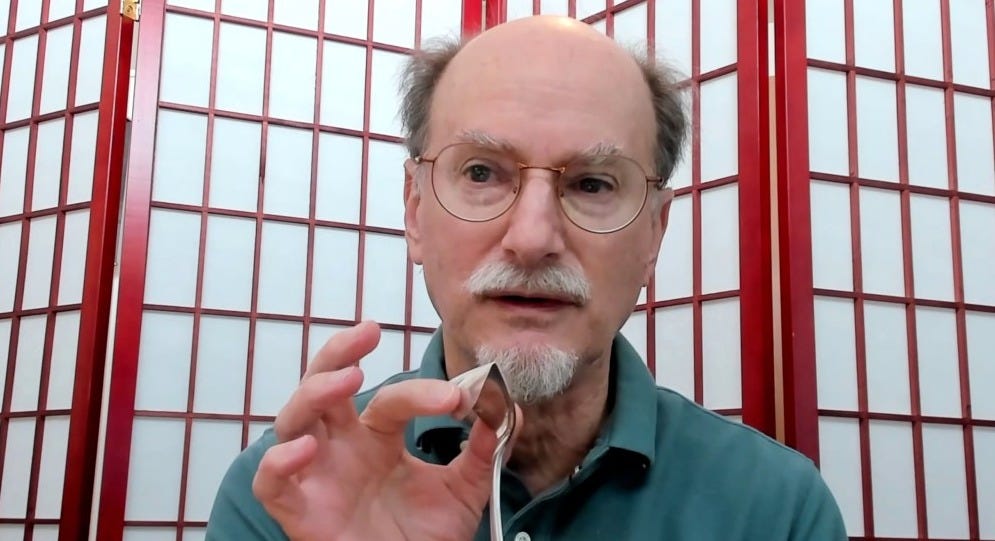 Dean Radin bending a spoon