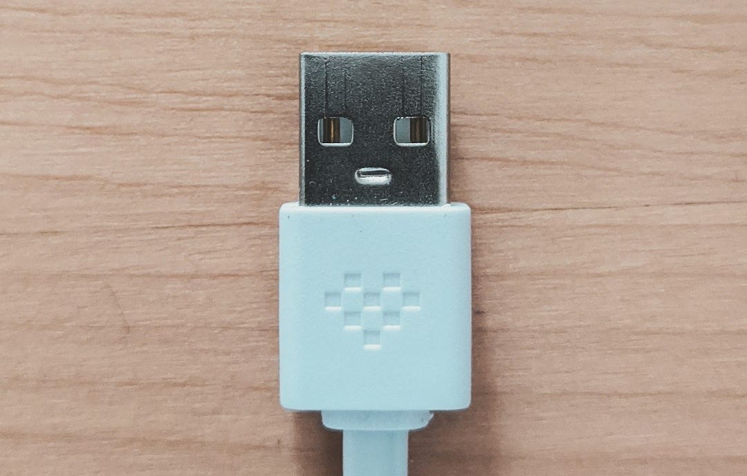 white usb flash drive on brown wooden table