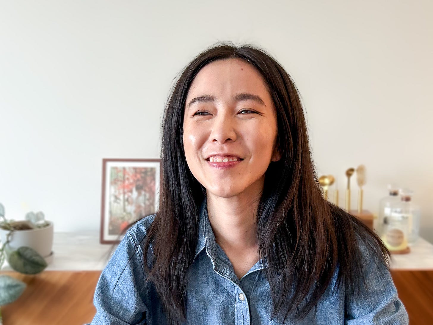 Headshot of woman with black hair laughing