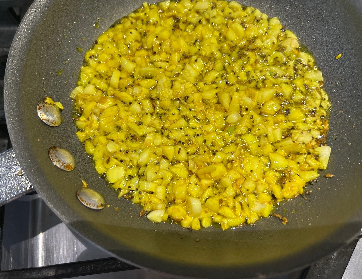 Roasting garlic pieces in tadka
