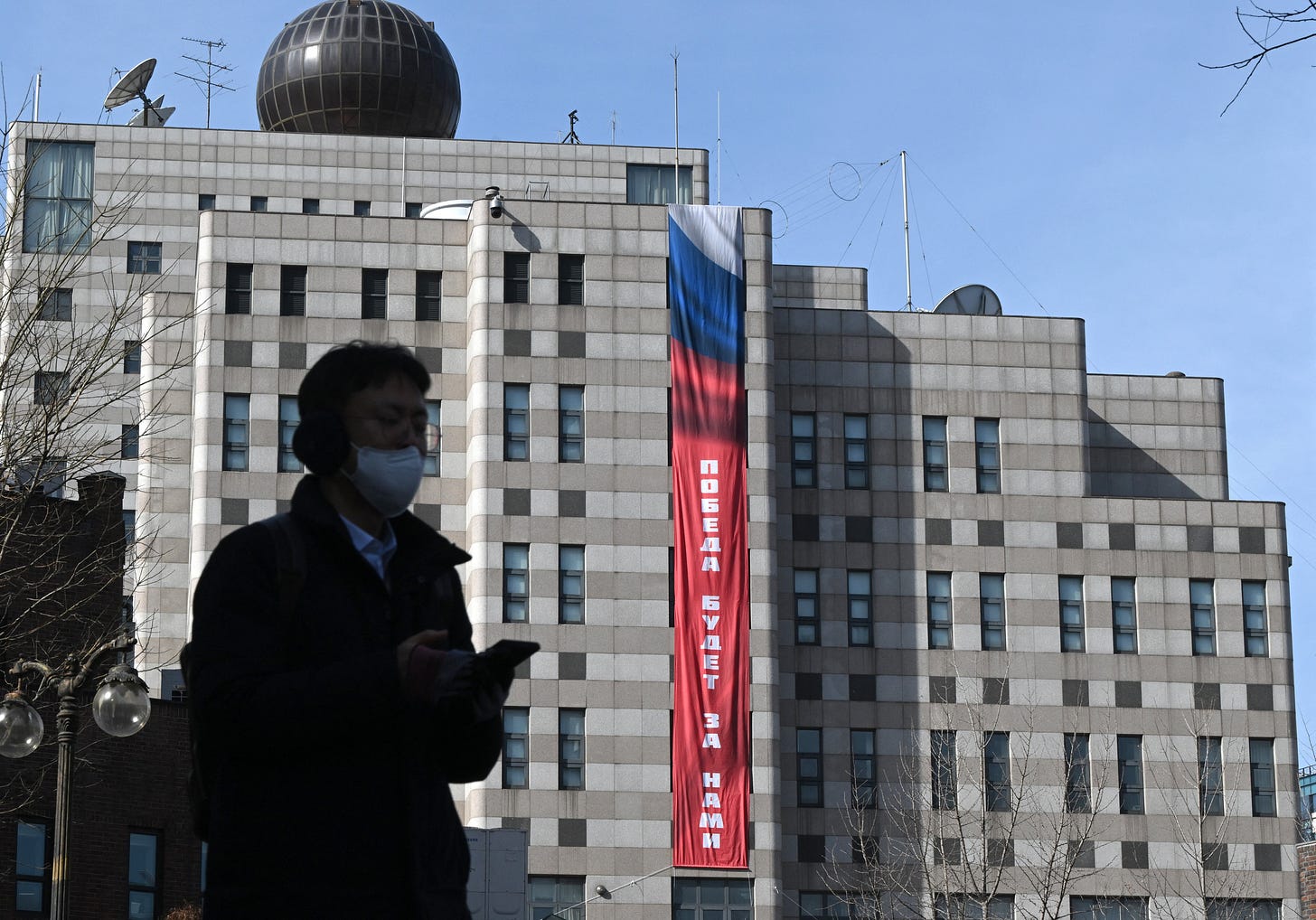 A man walks in front of the Russian embassy in Seoul where the banner is displayed A man walks in front of the Russian embassy in Seoul where the banner is displayed