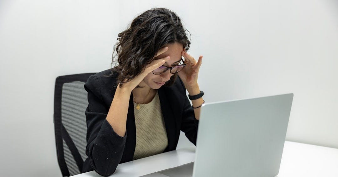 a woman sitting in front of a laptop computer a woman sitting in front of a laptop computer