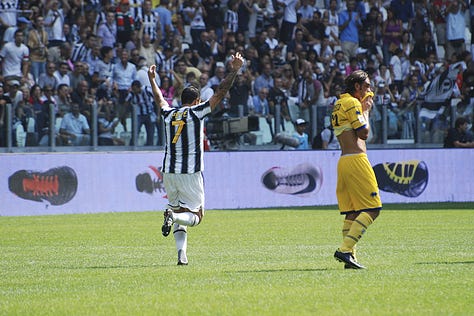 Juventus vs Parma, September 11, 2011: Arturo Vidal celebrates scoring on his debut, Juventus players embrace, fans erupt in celebration, Del Piero and teammates on the pitch, and Gianluigi Buffon giving a thumbs up during the opening match at Juventus Stadium.
