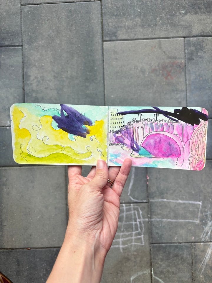 Hand holding up drawing of bridge in downtown Minneapolis