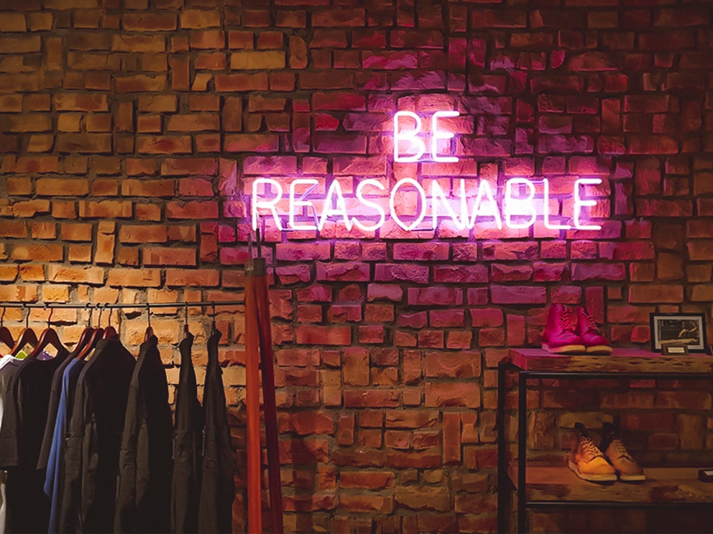A brick wall with a sign and clothes on it

Description automatically generated