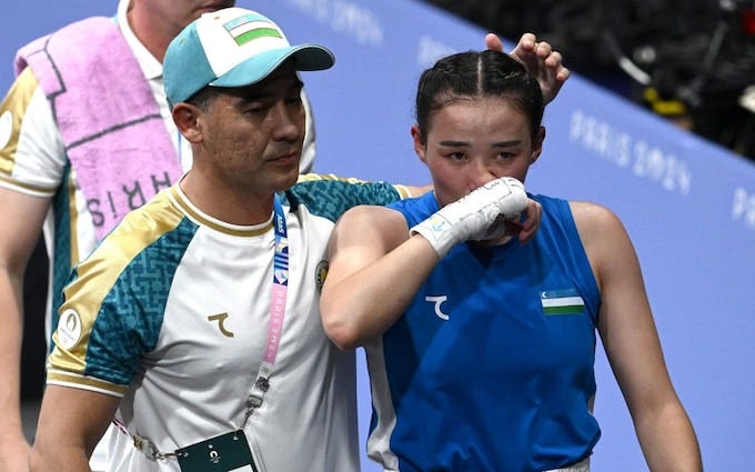 A tearful Sitora Turdibekova is consoled by her coach A tearful Sitora Turdibekova is consoled by her coach