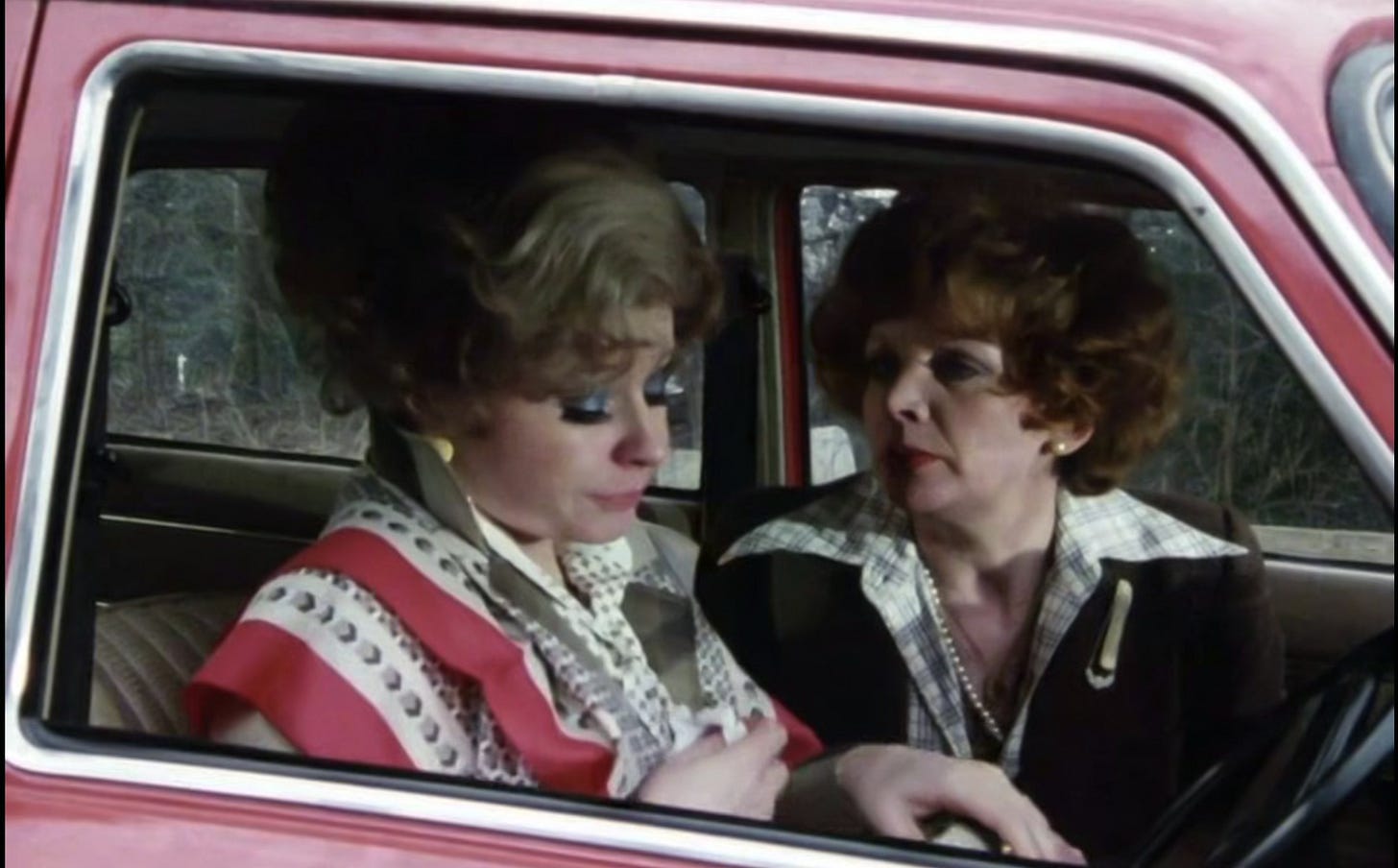Sybil Fawlty in her car with her friend, upset because Basil forgot their anniversary