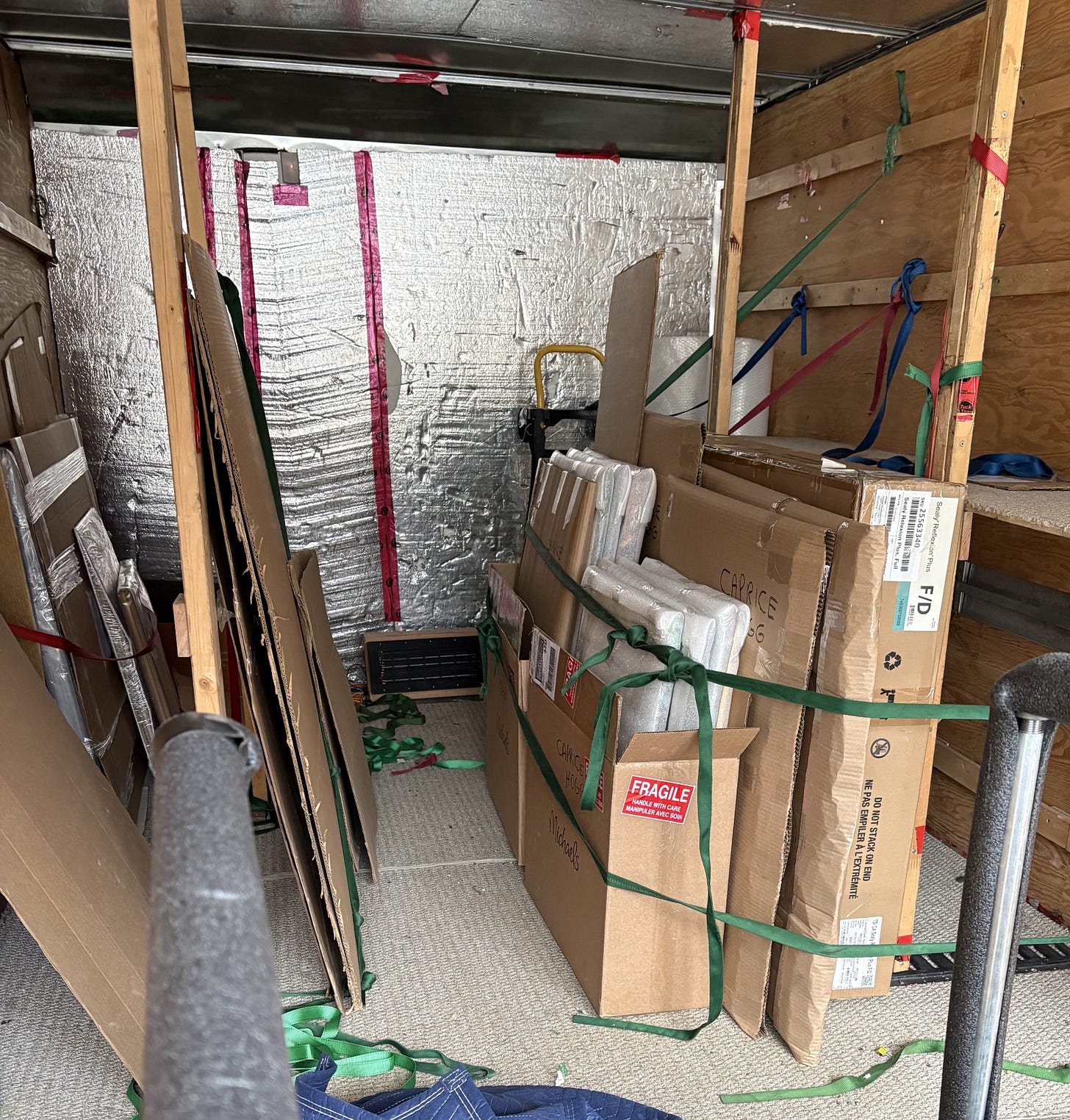 The oil paintings are packed and strapped into the moving van. The art mover carefully transports them to the Esplanade Art and Heritage centre in Medicine Hat.