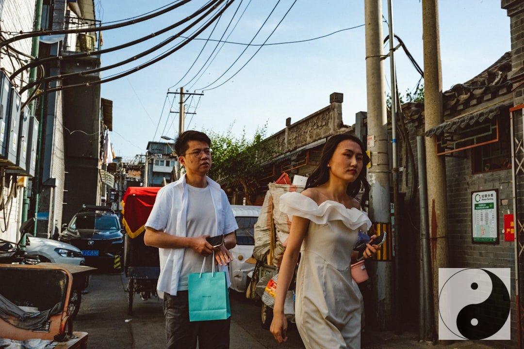 a man and a woman walking down a street