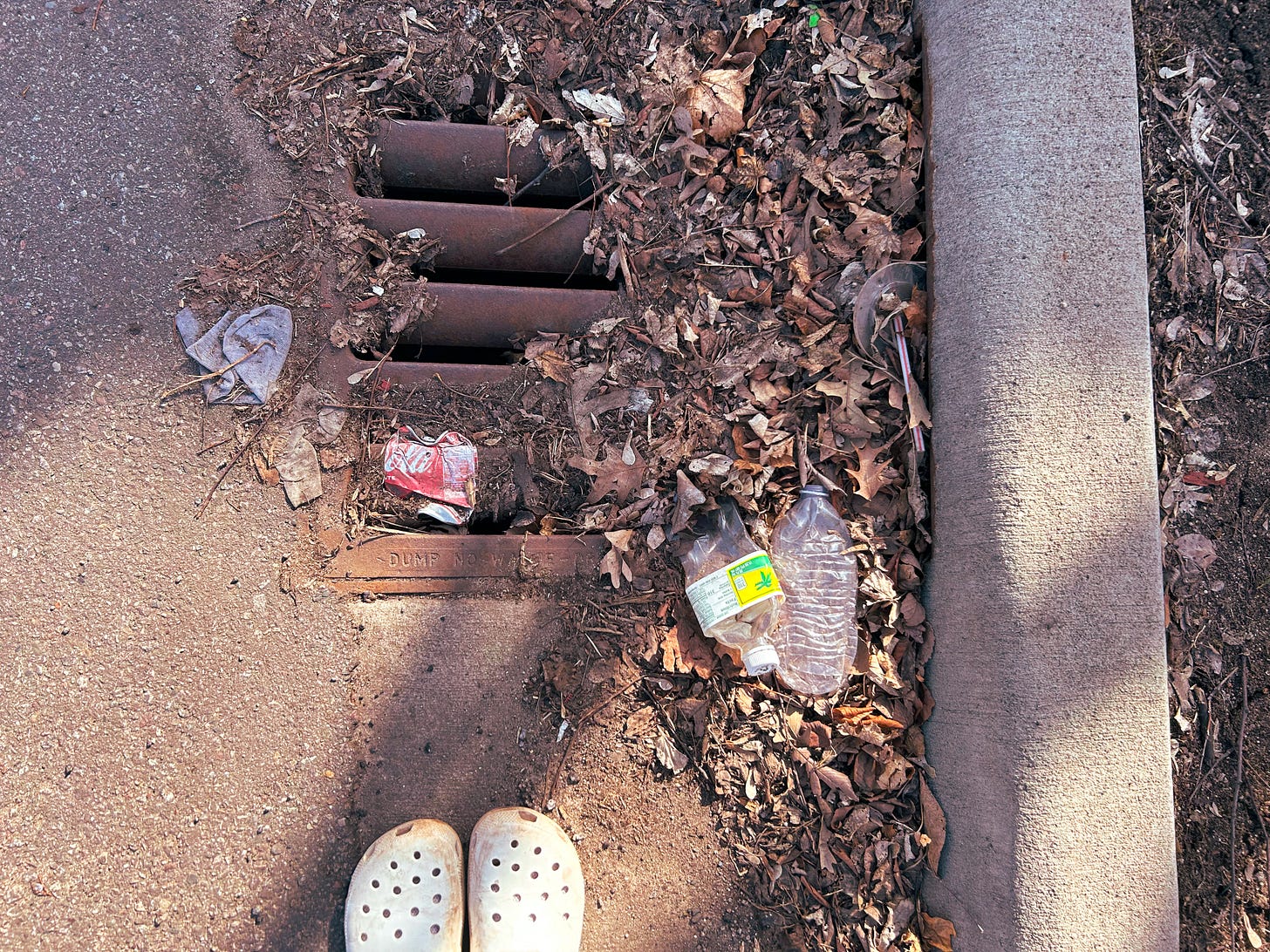 Picture shows trash on the road and a peak at Lisa's crocs. 
