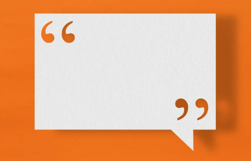 Graphic of a white piece of blank paper with orange quote icons on either side